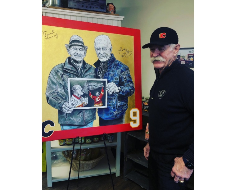 Photo of Lanny McDonald signing a portrait by Kim Parrent