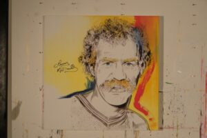 Painting of Lanny McDonald in red, yellow and blue with his autograph, by Kim Parrent